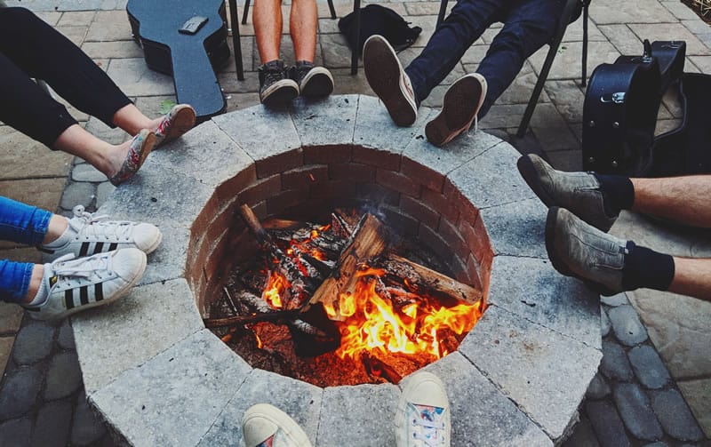 people sitting around a firepit